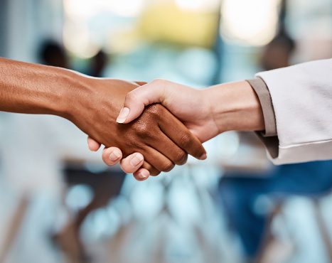 Cropped shot of a doctor shaking hands with an unrecognisable woman