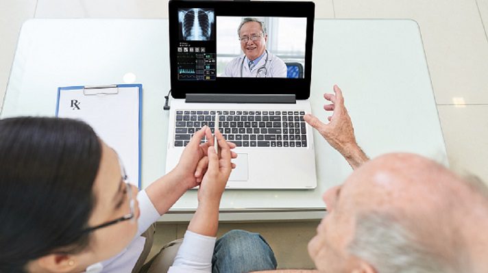 Senior man and his doctor having video conference with experienced medical worker