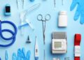 Medical supplies and devices arranged on a light blue background, including a stethoscope and blood pressure monitor.